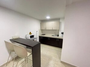 Fridge, microwave, stovetop, coffee/tea maker