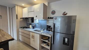 Fridge, microwave, stovetop, coffee/tea maker