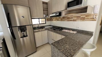 Fridge, microwave, stovetop, cookware/dishes/utensils