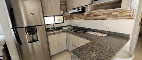 Fridge, microwave, stovetop, cookware/dishes/utensils