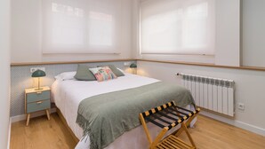 Makuuhuoneessa on sänky, yöpöydät, patteri ja pyykiteline.