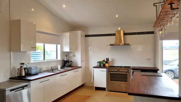 A modern kitchen with white cabinets, stainless steel appliances, and a wooden countertop. - Brooksea at Balgowan, Balgowan (Balgowan)