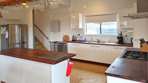 A modern kitchen with a wooden countertop, stainless steel appliances, and a window providing natural light. - Brooksea at Balgowan, Balgowan (Balgowan)