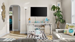 A modern living room with a flat-screen TV, a potted plant, and a sofa with decorative pillows.