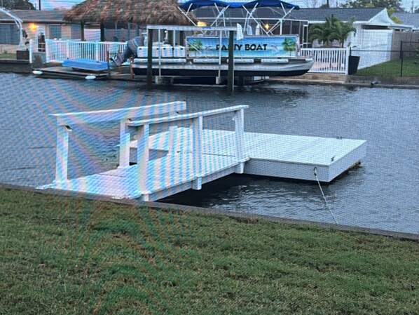 A boat docked at a pier with a 'FAMILY BOAT' sign, a small dock, and a grassy area in the foreground. - 2 Bedroom, 2 1/2 Bath Waterfront Home. Kayaks. Dogs welcome (Hudson)