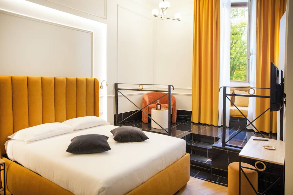 Junior Triple Room, Garden View | Minibar, in-room safe, desk, laptop workspace