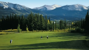 A golf course with a mountainous backdrop. - Grande Cache Hotel (Grande Cache)