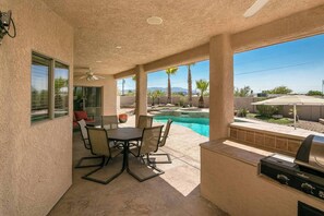 A covered patio with a pool, outdoor seating, and a grill. - Downtown Pool Home and boat parking (Lake Havasu City)