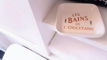 A white ceramic container with the text "LES BAINS DE L'OCCITANE" on it.