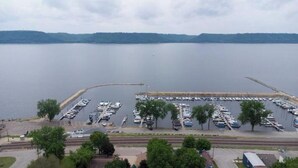 A marina with boats docked, a bridge, and a view of a lake. - Harbor Hill Inn - Penzance Suite (Pepin)