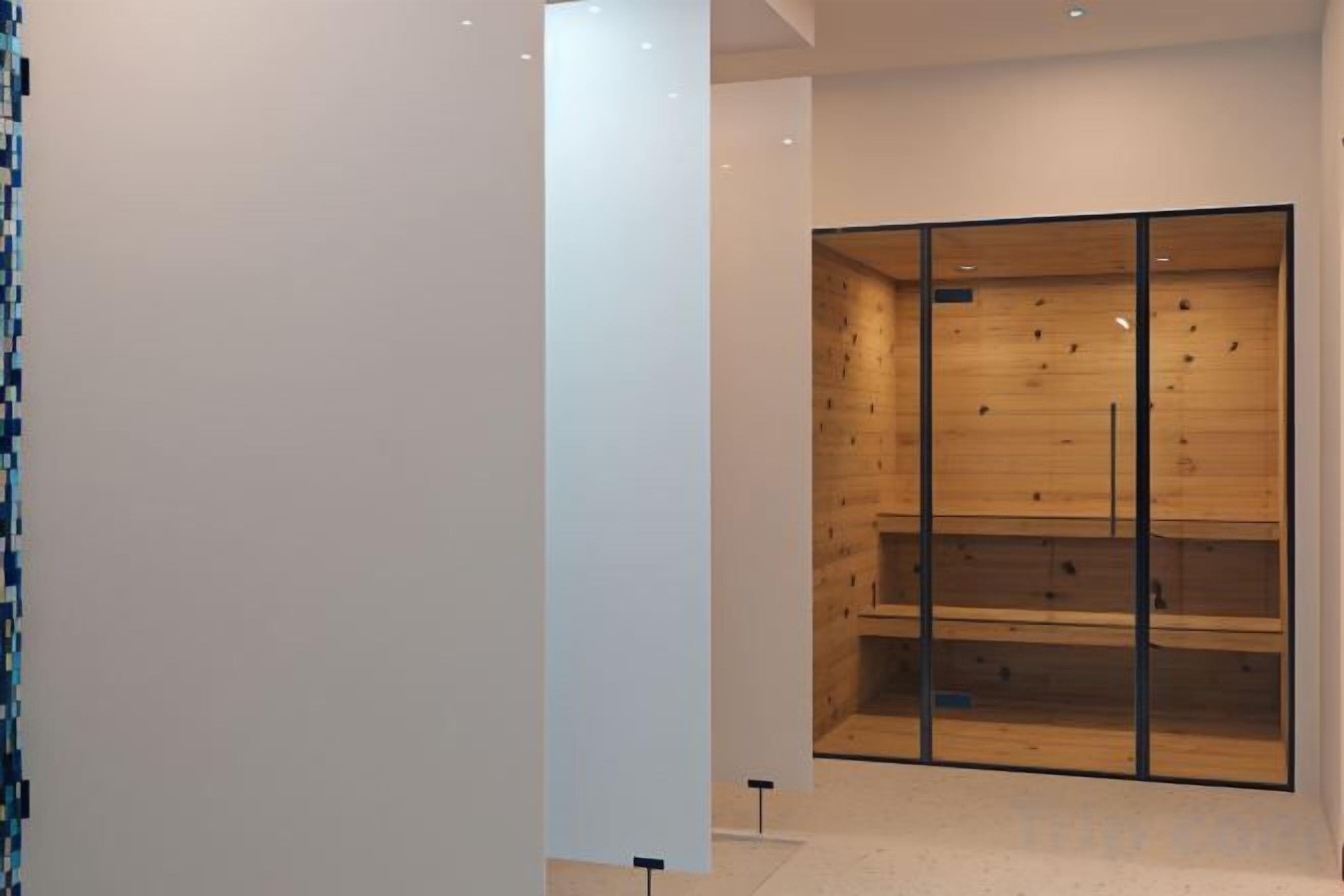A modern interior with a wooden wall and a glass partition.