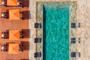 A top-down view of a swimming pool area with lounge chairs and umbrellas. - Regency Salgados Hotel & Spa (Guia)