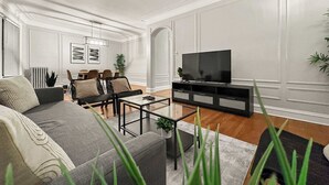 A modern living room with a sofa, coffee table, and TV.