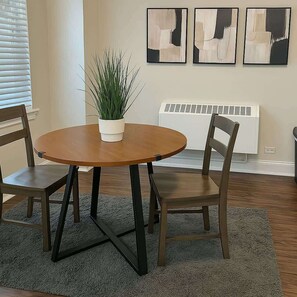 Enjoy meals in this cozy dining area with a round table and comfortable chairs.