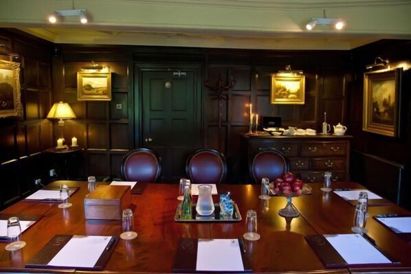 A conference room with a long table, chairs, and a cabinet with framed pictures. - Cbh Whitley Hall Country House Hotel (Sheffield District)