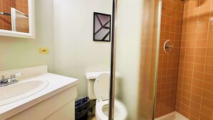 A bathroom with a shower, toilet, and sink. - Paradise 1BR Apt in Lincoln Park (Chicago)