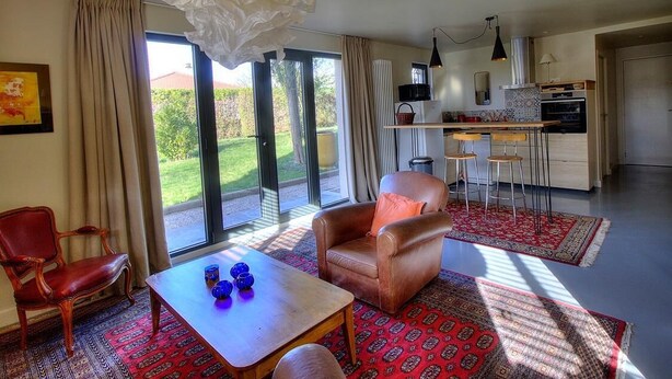 A spacious living room with a large window, a dining area, and a kitchen. - La Maison de Craponne (CRAPONNE)