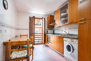 Fridge, microwave, coffee/tea maker, cookware/dishes/utensils