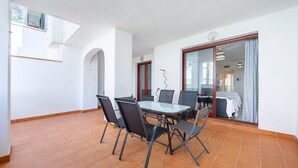 A dining area with a table and chairs, a window, and a door leading to another room. - 'Incredible Playazo Vera' Apartment with Shared Pool, Private Terrace & Air Conditioning (Vera)