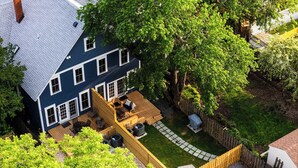 A two-story house with a deck, a fenced yard, and a small shed. - Swans Rest Townhouse, Close to Beach & Restaurants (Cape Charles)