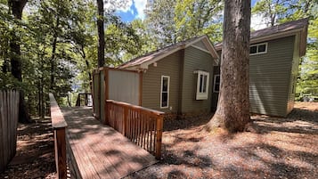 Escape to a secluded cabin surrounded by mature trees and enjoy the natural beauty from the deck.