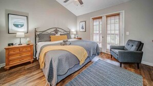 A bedroom with a bed, a chair, a dresser, and a ceiling fan. - LOCATION!!  Only 1 mile to downtown Helen. 2 Bedroom, 2 Bath. Gated Community. (Helen)