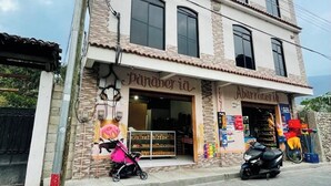 A two-story building with a bakery named "Panadería" on the ground floor and another named "Abarrotería" on the second floor. - hostal bode de lago rooms  #3 (Panajachel)