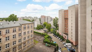 A multi-story residential building with a parking area in front. - National Stadium Spacious Apartment (Warszawa)