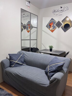 Living area - 2-bedroom condo in delightful Davao City with WiFi, AC (Davao City)