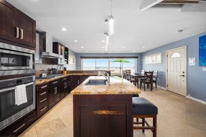 Enjoy meals in the kitchen with a central island, double oven, and microwave, plus a dining area with a table and chairs.
