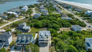 An aerial view of a coastal residential area with houses, roads, and a beach. - Everyone can relax at Salt Life (Topsail Beach)