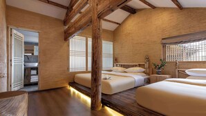 A traditional Japanese-style room with tatami flooring, a wooden ceiling, and a sliding door leading to a bathroom.