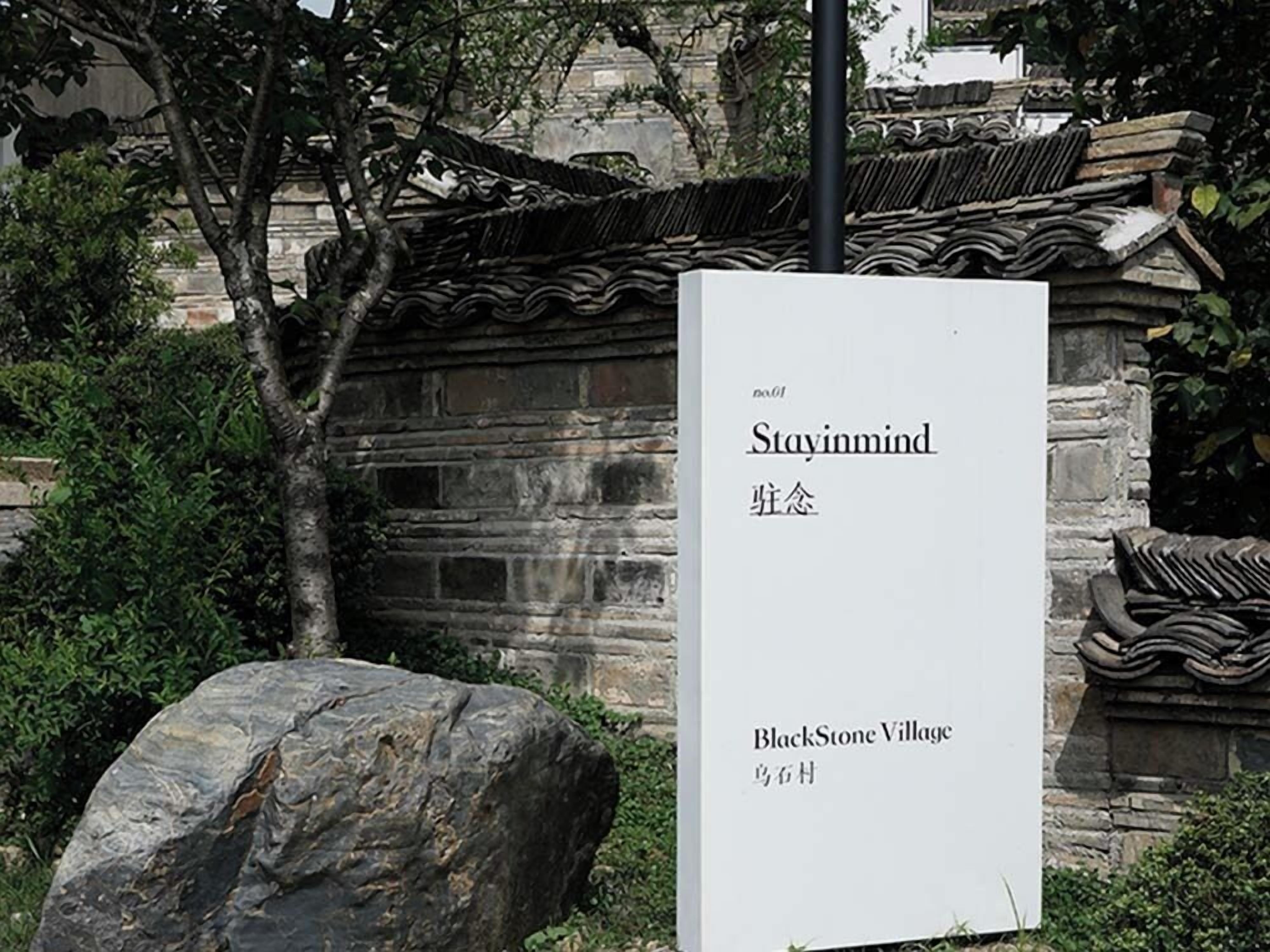 Ein Schild für BlackStone Village mit dem Schriftzug 'Stayinmind' und chinesischen Schriftzeichen.