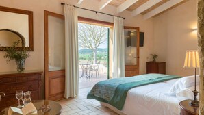 A bedroom with a bed, a dresser, a mirror, and a view of the outdoors. - GOSSALBA - DELUXE - Nice room in agriturismo with shared pool and free Wifi (Sant Joan)