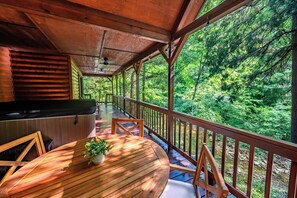 Enjoy outdoor dining with a barbecue grill and forest views.