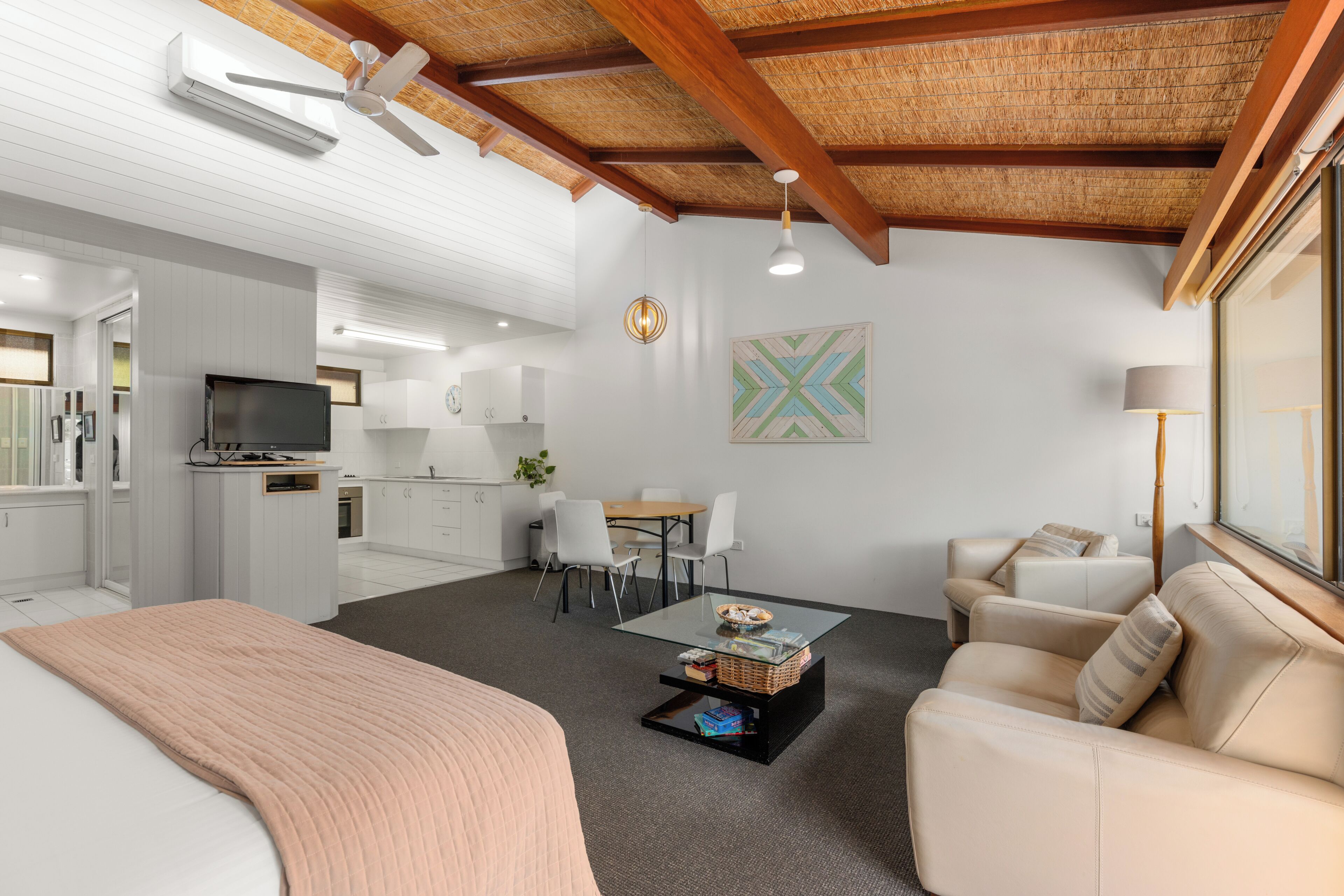 A modern interior with a dining area, kitchen, and living space.