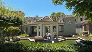 A residential area with a gazebo, well-maintained lawn, and houses with similar architecture. - Charming and Spacious 2B + 2.5 Bath Townhome (Pasadena)