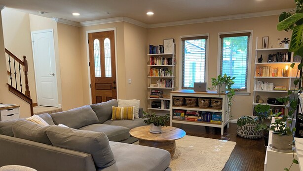 A living room with a grey sofa, a coffee table, and a bookshelf filled with books. - Charming and Spacious 2B + 2.5 Bath Townhome (Pasadena)