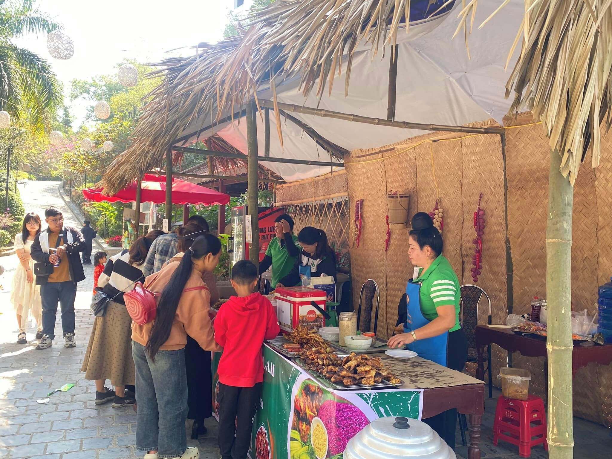 A street food stall with a variety of grilled items displayed on a metal rack.