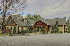 A two-story building with a prominent entrance, a covered porch, and a landscaped front yard. - Pet-Friendly Blue Ridge Stay w/ Resort Perks (Sapphire)