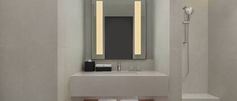A modern bathroom with a large mirror, a sink, and a shower.
