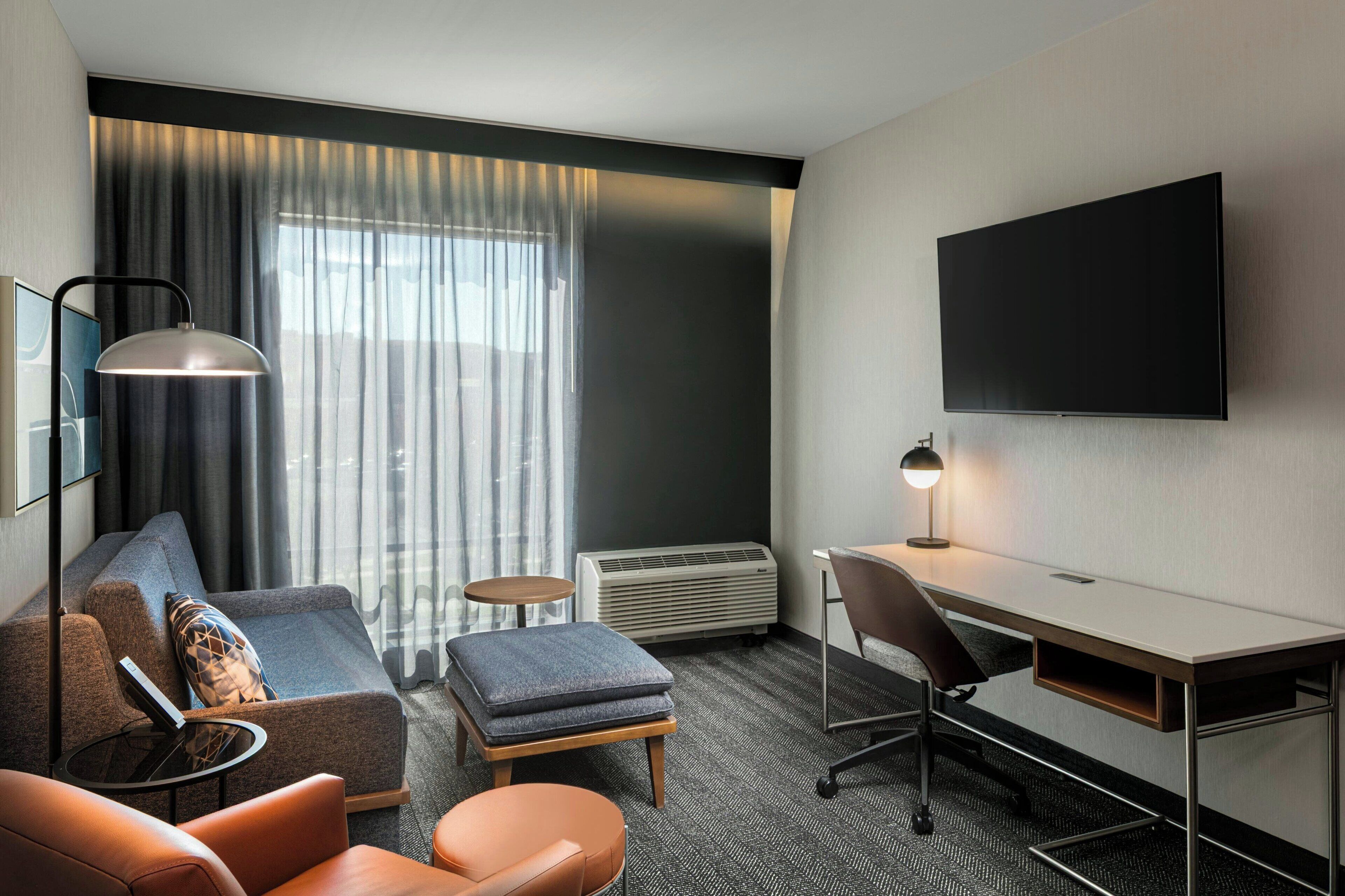 Suite, 1 King Bed with Sofa bed, City View | Living area | 55-inch Smart TV with cable channels, streaming services