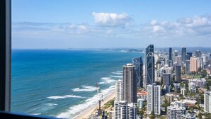 A coastal cityscape with high-rise buildings, a beach, and the ocean. - Sky Home on 54th Floor - Stunning South East Views (Surfers Paradise)