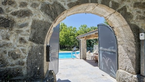 An outdoor swimming pool area with stone walls and a pergola. - Stone Villa Galant with Pool (Lanisce)