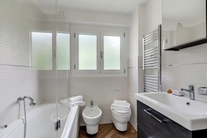 Bathtub, bidet, towels, soap