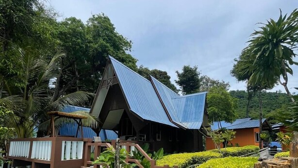 A resort with a pool area, a wooden deck, and a house with a sloped roof. - Suite Sharilla (Pulau Perhentian Kecil)