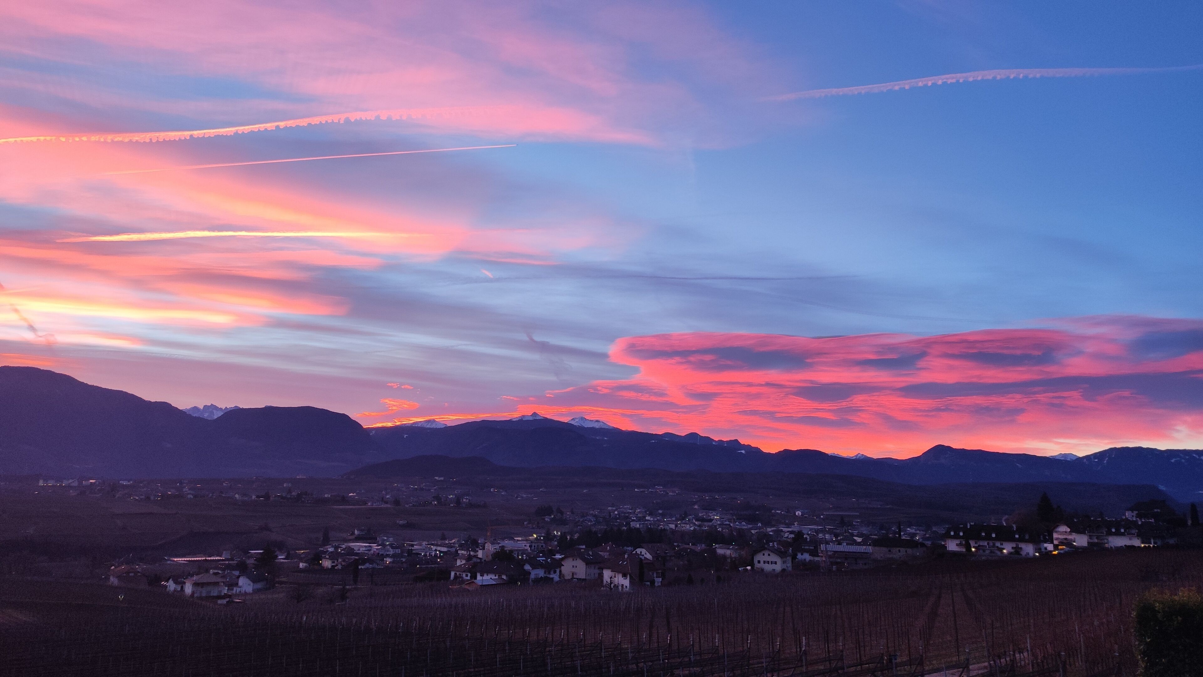 A mountainous landscape with a town in the valley.