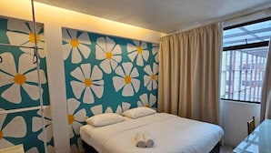 A bedroom with a bed, a desk, and a window with curtains. - V Garden Hotel by Minsu (Kuala Lumpur)
