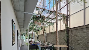 An outdoor patio area with artificial grass, a wooden table, and chairs. - V Garden Hotel by Minsu (Kuala Lumpur)