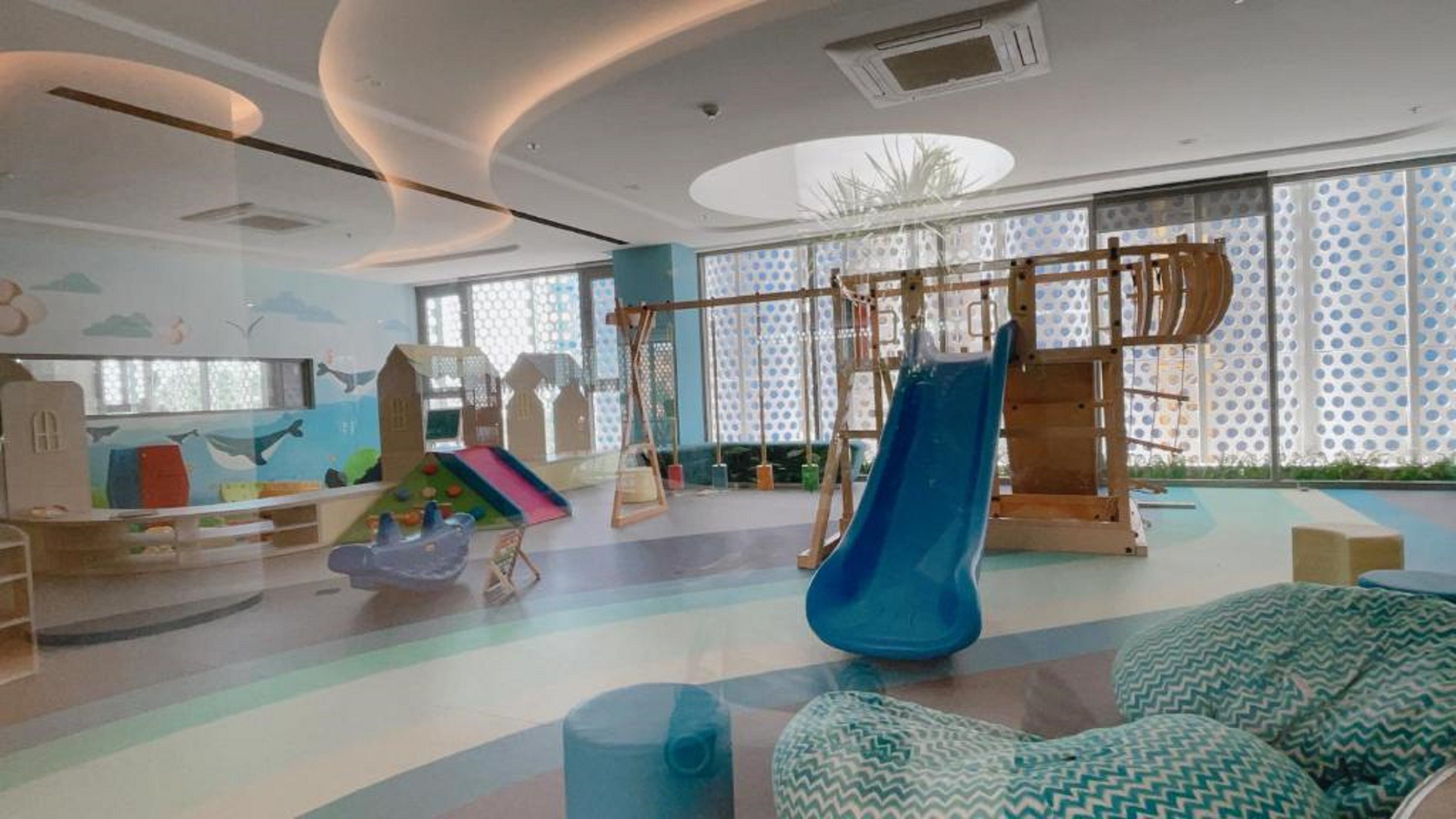 A children's play area with a slide, climbing structures, and colorful play equipment.